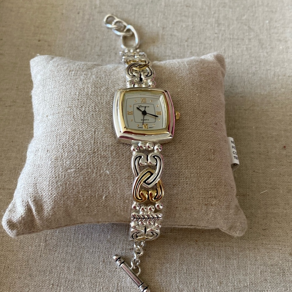 Beautiful silver and goldtone Geneva Quartz watch with toggle closure.